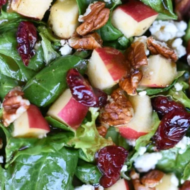 Freshly prepared Apple Pecan Salad with apples, pecans, and vinaigrette
