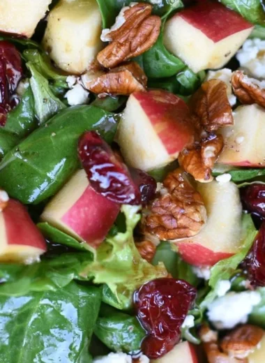 Freshly prepared Apple Pecan Salad with apples, pecans, and vinaigrette