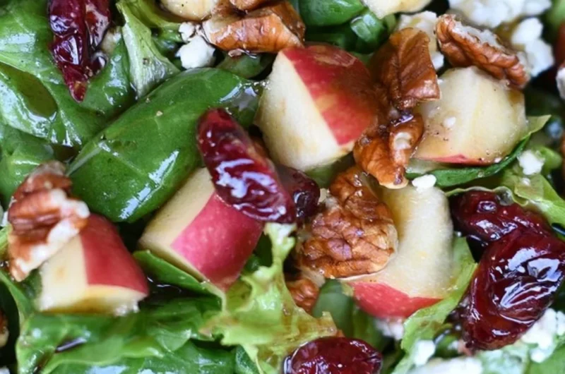 Freshly prepared Apple Pecan Salad with apples, pecans, and vinaigrette