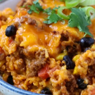 Delicious beef enchilada casserole with rice served in a colorful dish