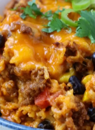Delicious beef enchilada casserole with rice served in a colorful dish