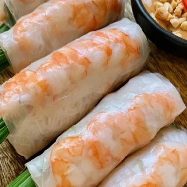 Plate of fresh Vietnamese spring rolls with herbs and dipping sauce