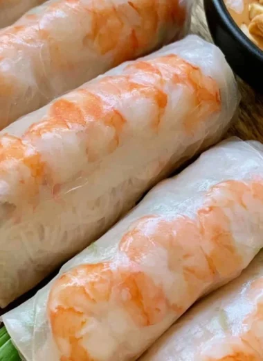 Plate of fresh Vietnamese spring rolls with herbs and dipping sauce