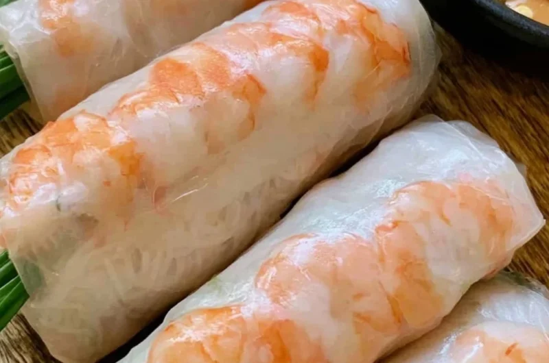 Plate of fresh Vietnamese spring rolls with herbs and dipping sauce