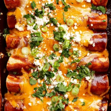 Plate of homemade black bean enchiladas topped with cheese and salsa