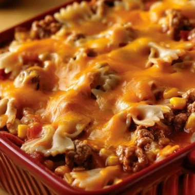 Cheddar Sloppy Joe Casserole topped with melted cheese in a baking dish