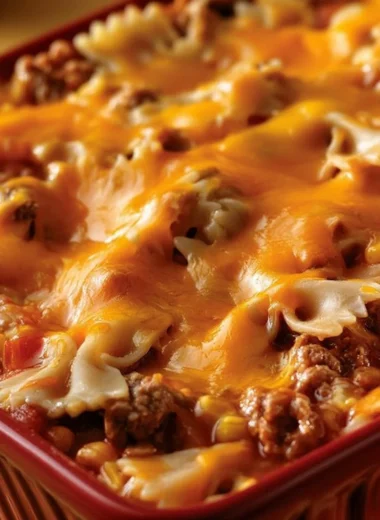 Cheddar Sloppy Joe Casserole topped with melted cheese in a baking dish