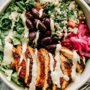 Healthy Chicken Shawarma Meal Prep Bowls with fresh vegetables and sauces.