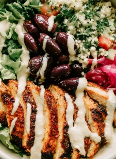 Healthy Chicken Shawarma Meal Prep Bowls with fresh vegetables and sauces.