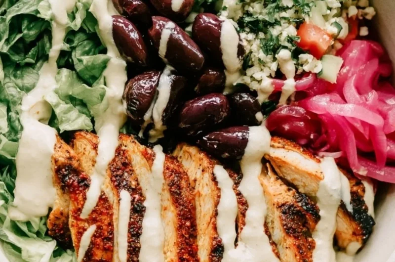 Healthy Chicken Shawarma Meal Prep Bowls with fresh vegetables and sauces.