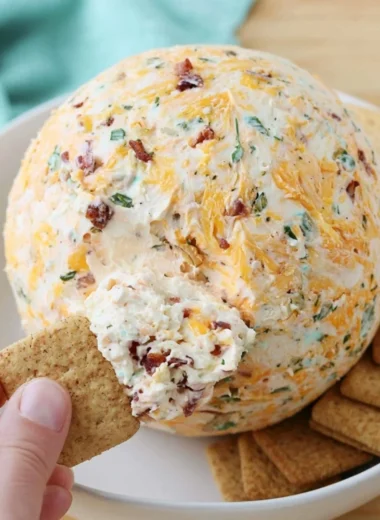 Delicious easy cheese ball appetizer served on a platter with crackers and veggies