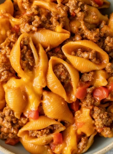 High protein taco pasta dish with colorful toppings and ingredients