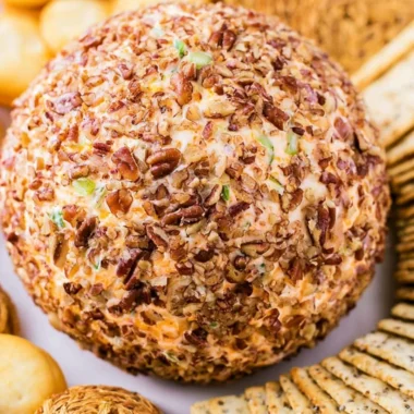 Delicious holiday cheese ball decorated for festive gatherings.