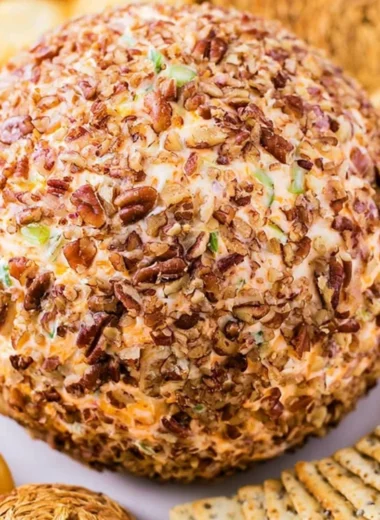 Delicious holiday cheese ball decorated for festive gatherings.