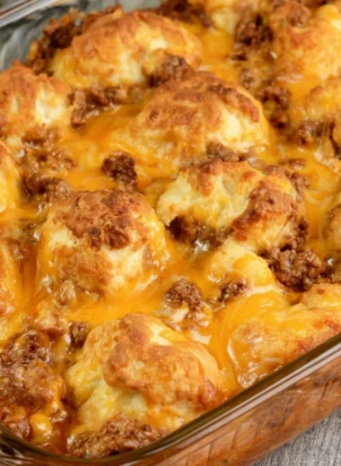 Casserole dish filled with Sloppy Joe Biscuit Casserole, topped golden brown.