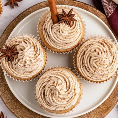 Spiced chai latte cupcakes topped with cream, perfect for fall baking and desserts.