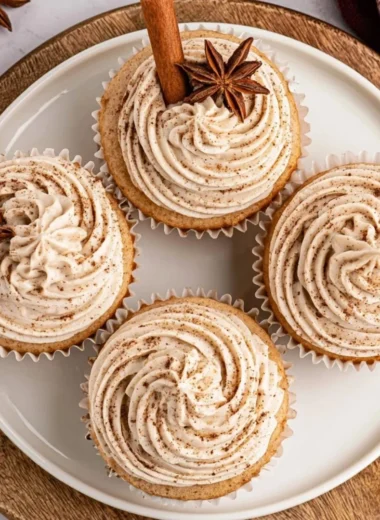 Spiced chai latte cupcakes topped with cream, perfect for fall baking and desserts.